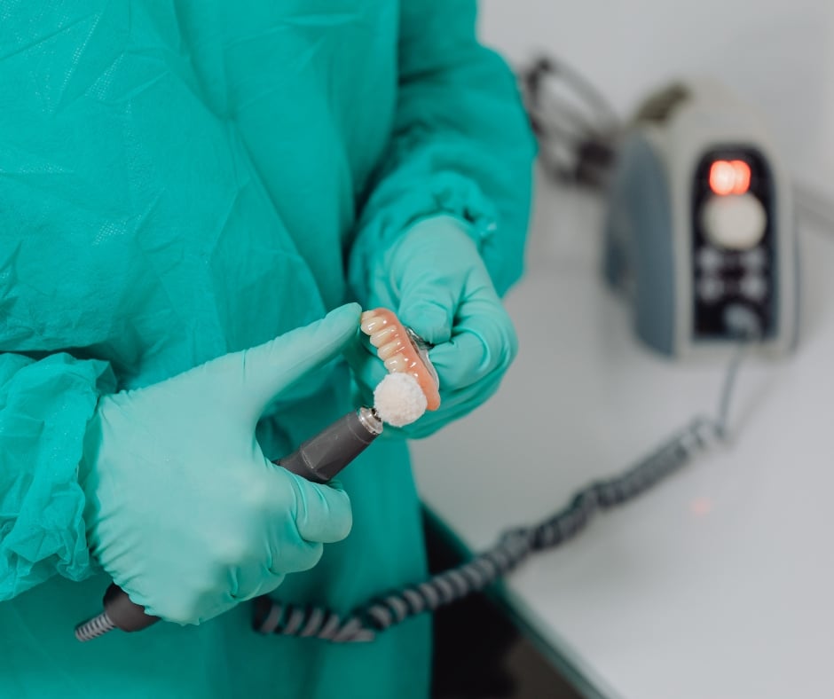 lab technician doing denture adjustment in nottingham